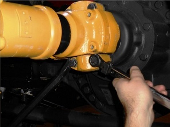 Use jack to raise drive shaft into position for bolt installation