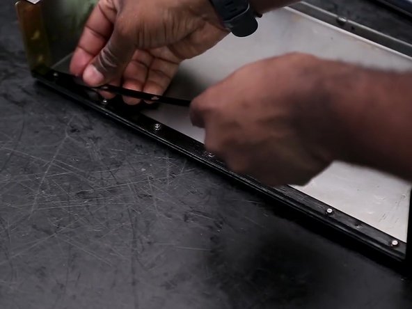 Install the retainer over the top of the wiper.