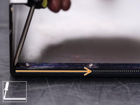 Using a flathead screwdriver slide the retaining strip towards the opposite end of the waycover to disengage from the standoffs.