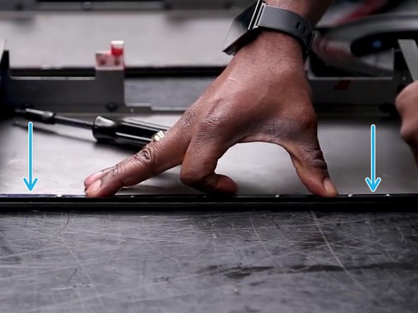 With one hand, apply downward pressure to the retainer.