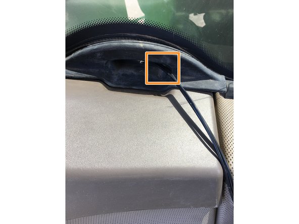 Insert the cable through the notch in the back window of the cab.