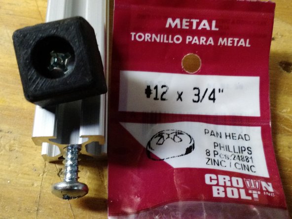 Screw the feet into the vertical extrusions.