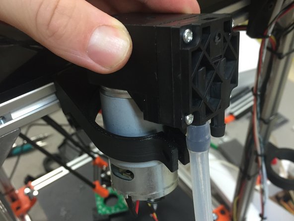 Locate the vacuum pump into the mount, as shown.