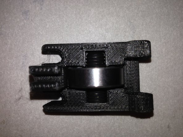 The Guidler is a Portmanteau on the words 'guide' and 'idler.  The guidler serves both functions.  It guides the filament into the extruder, and  the idler, as its name suggests,  transmits no power but applies tension to the filament.