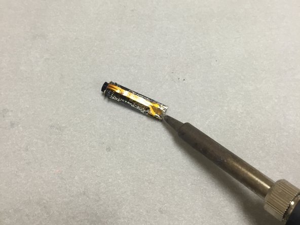 Use a soldering iron to remove the flat-flex cable.