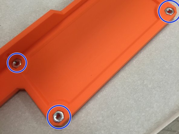 Insert the four M3 nuts into the frame nut traps.