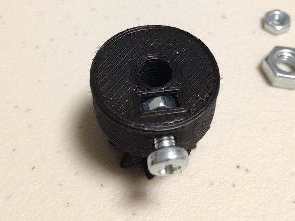 Insert M3 screw and partially screw in, but not far