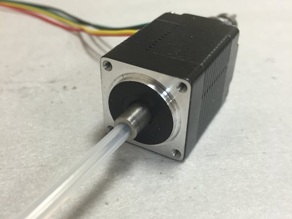 Insert the small tubing into the hollow shaft.  Shove it down as far as it will go (~3-4 mm or so).