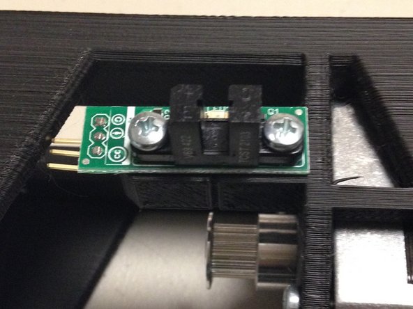Insert 2x M3 x 20L screws through the PCB, and into the 3D printed bracket.  Note the orientation, with the connector on the left, away from the motor.