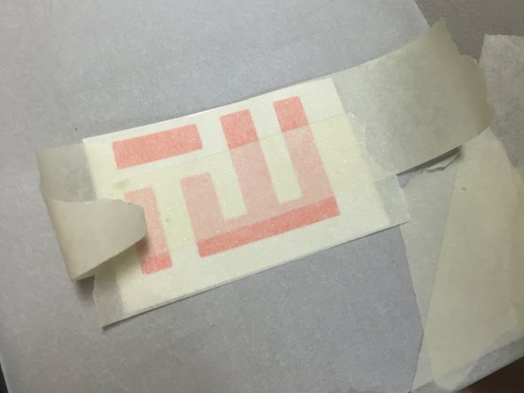 Locate the Tin Whiskers Technology vinyl sticker in your kit.  Cover the sticker with regular masking tape.