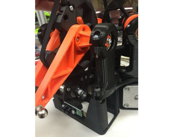 Wrap the belt around the stepper motor pulley, and hold it tightly, up against the pulley, as shown.