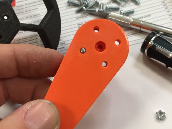 Remove the brim on the smaller end of the arm, and the support material in the two nut traps