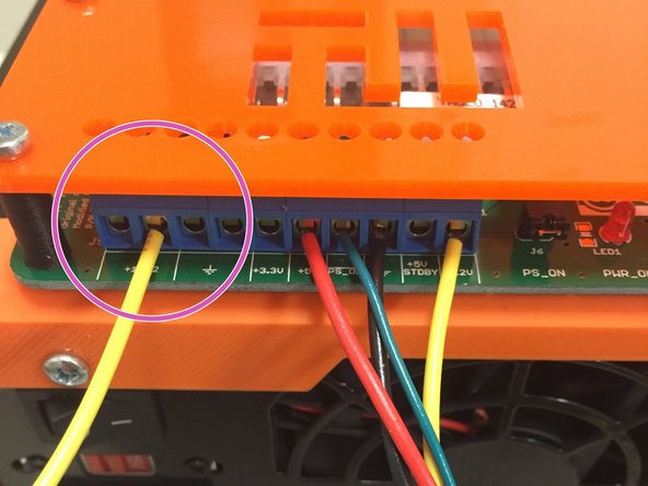 Plug the yellow wire into ATX power supply terminal strip, as shown in the picture.  Tighten the screw until the wire is secured.