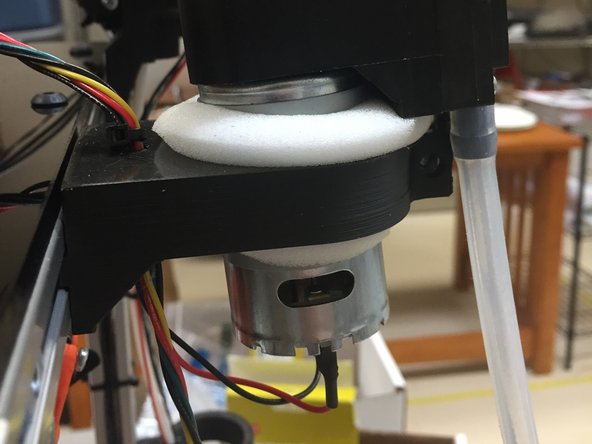 Carefully try to compress the foam and slide it down so that it comes out the bottom of the mount.