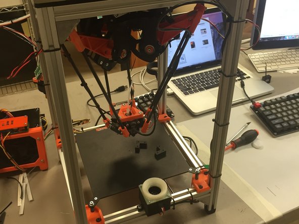 The delta mechanism is movable while it is powered down.  This is normal.