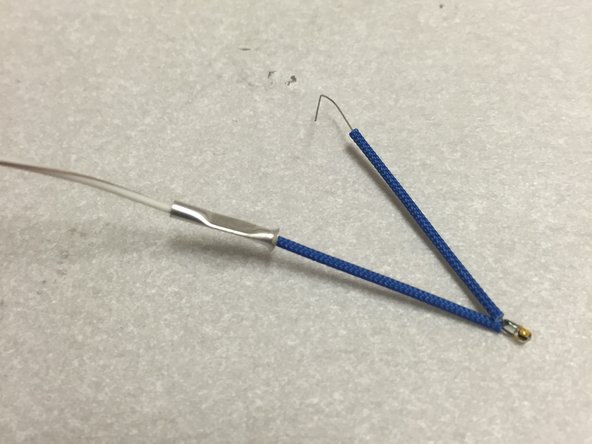 Make sure that the blue fiberglass insulation is still firmly pressed against the glass bead.  Hold it there with your thumb and forefinger.