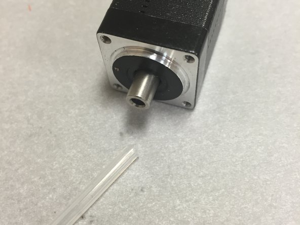 Insert the small tubing into the hollow shaft.  Shove it down as far as it will go (~3-4 mm or so).