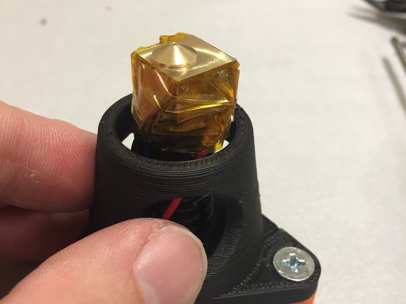 Wrap the J-Head brass heat-block with Kapton tape.  Pay special attention to make sure that the thermistor is properly secured into the thermistor hole, and that it doesn't move around.
