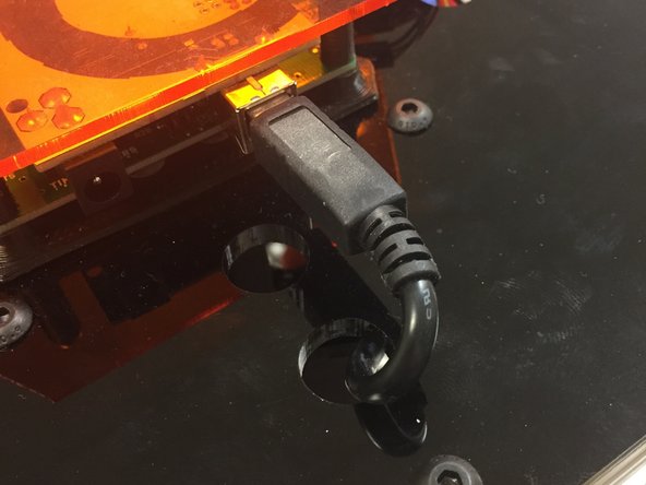 Connect the USB cable to the Arduino.  It is advised to route the excess cable out the hole in the PC01 plate, and down the side of the machine.