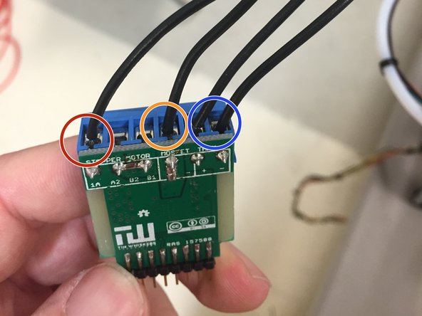 Screw the 18 AWG black wire from the heated bed PCB into the terminal circled in RED.