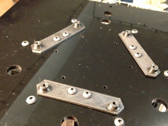 Add 3D0015a mounting plates to PC01 plate.  Use M5 button-head cap screws to fasten as shown.  Note the orientation of the 3D0015a pieces.
