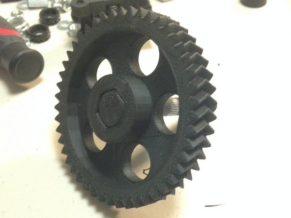 Insert the 'FHEX-M8-60L-HOBBED' bolt through the 3DAT0002 herringbone gear.