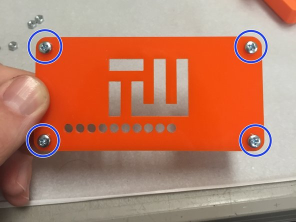 Put the M3 screws through the acrylic plate, noting the orientation in the pictures to the left.