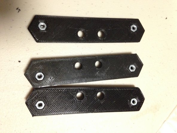 Insert M3 nuts into nut traps.