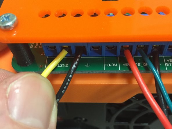 This is the OTHER piece of wire from the kit!  Not the black wire that's connected to the PCB.  DON'T connect the PCB black wire to the power supply, because that will cause the bed to be constantly on which is UNSAFE!