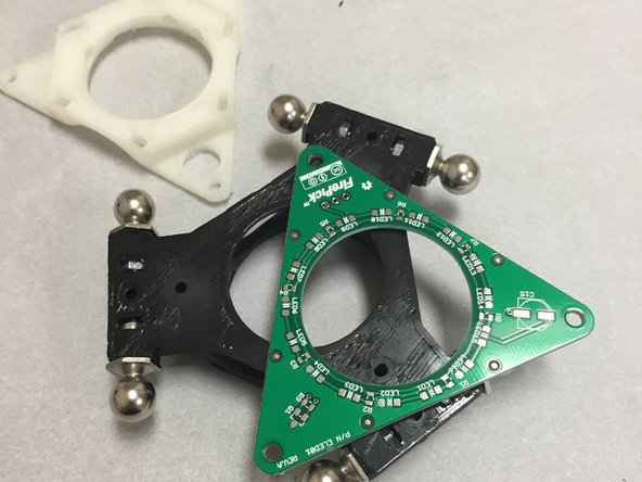 Locate the ELED01 ring light PCB and place it on the 3DAT0011a ATC hub.