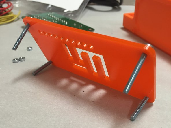 Put the M3 screws through the acrylic plate, noting the orientation in the pictures to the left.