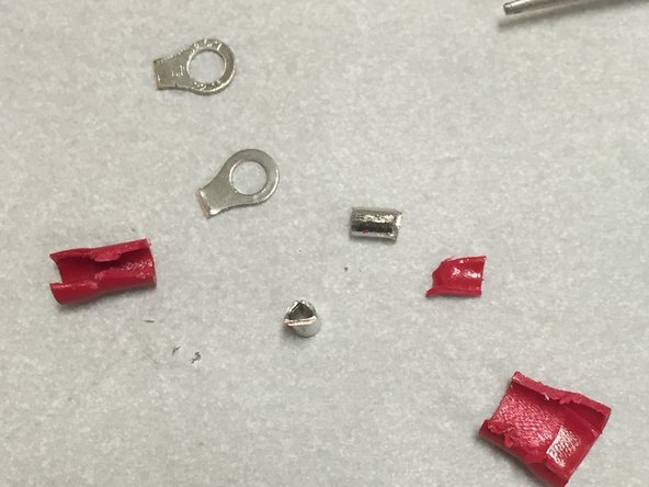 We're using red (22-16 AWG) insulated ring terminals.  You can find these at any hardware store, and most resourceful nerds will have a few of these in a drawer or bin somewhere.