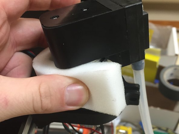 Wrap the piece of foam around the pump motor.