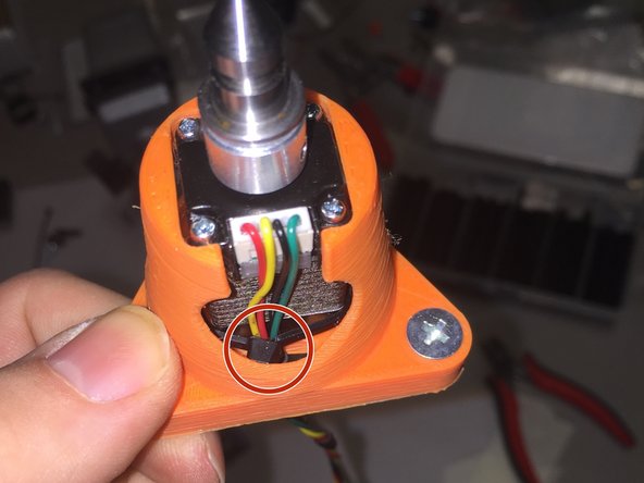 Use a cable tie to keep the stepper motor cable secured.  Thread it around the motor, and make sure to slide the zip tie towards the flange, so that the head doesn't stick out of the conical section.