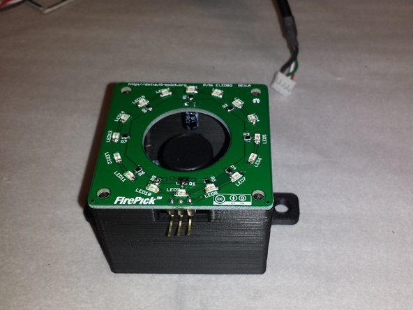 Place the right light onto the housing as shown.