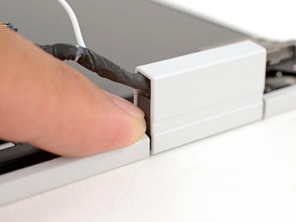 Use your fingers to press the clip into the hinge to secure the cables.