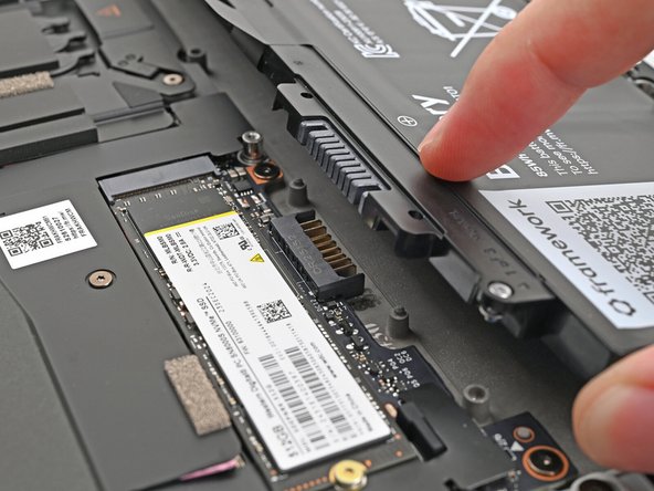 Align the battery connector over its socket and lay the battery into its well.