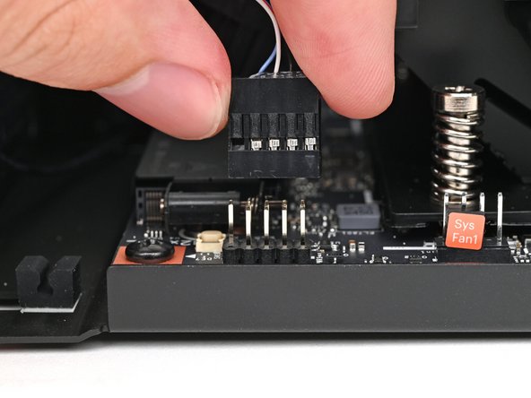 Use your fingers to lift the power button cable connector off its nine‑pronged socket on the Mainboard.