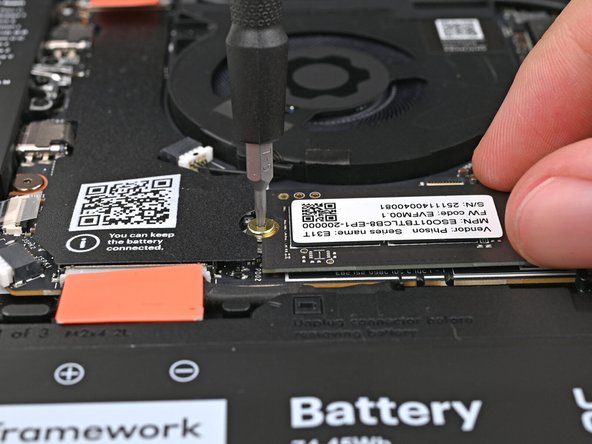 While holding the SSD flat to the Mainboard, use your Framework Screwdriver to install the 3.0 mm‑long T5 Torx screw securing the SSD.
