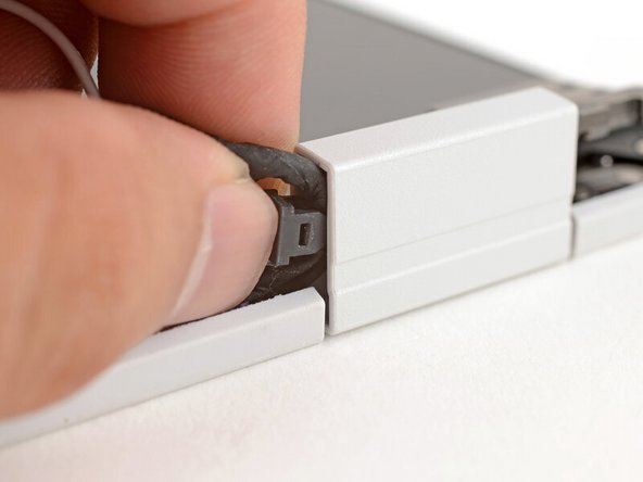 Place the cable clip around the right hinge cables, where they were bent from being inserted into the hinge.