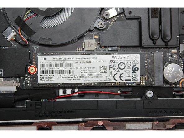 Using the T5 bit in the Framework Screwdriver, unscrew the fastener on the Storage module.