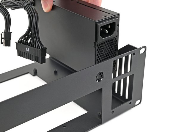 Place the power supply into its slot at the right edge of the Tray.