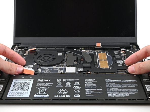 Use your fingers to lift the bottom edge of the Mainboard enough to grip its edges.