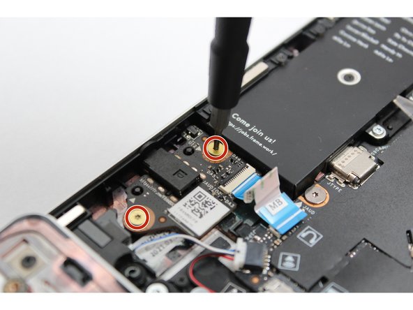 Using the T5 bit in the Framework Screwdriver, unscrew the two fasteners on the Audio Board.
