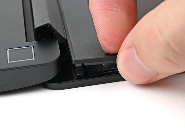 Slide your fingernail under the inside edge of either bottom corner of the Bezel.