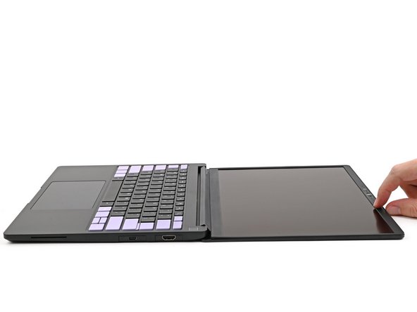 Open the laptop so the screen sits flat on your work surface.