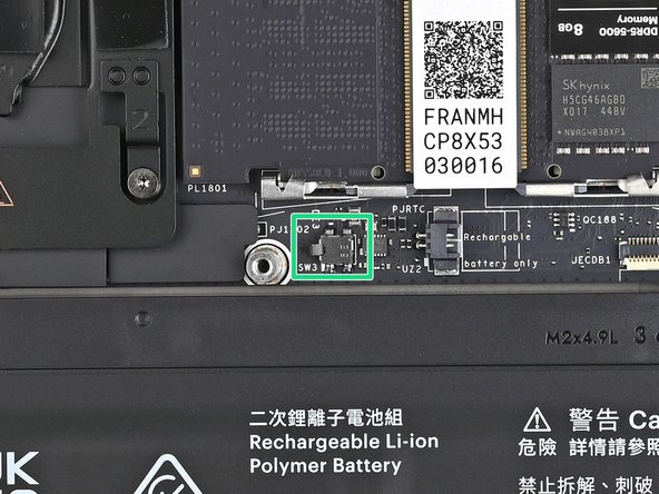 This switch is a sensor that detects if the Mid Plate has been removed. It's a small silver block with a black toggle tab.