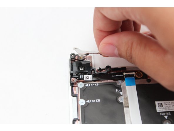 Gently lift the silver bracket off the module and move it away.