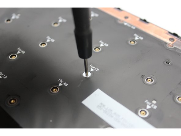 Using the PH0 bit in the Framework Screwdriver, screw all the silver fasteners into the slots marked  &quot;For KB&quot; that hold the keyboard in place.