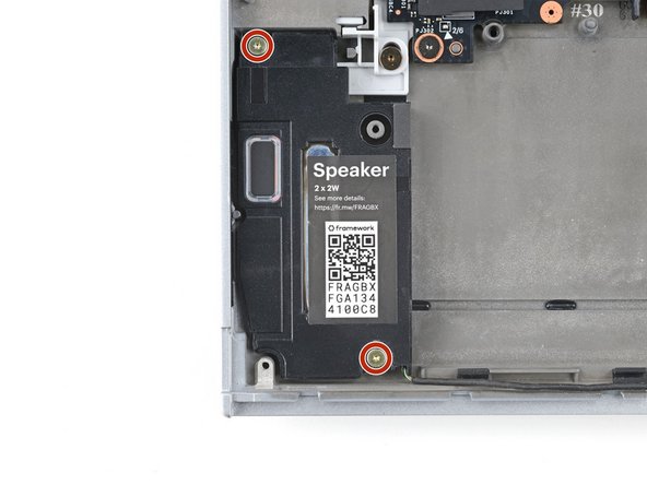 Use your Framework Screwdriver to remove the two 2.0 mm‑long T5 Torx screws securing each speaker (four in total).